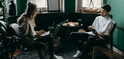 Two professionals in a modern office discussing digital marketing roles and remote career opportunities at BitBop