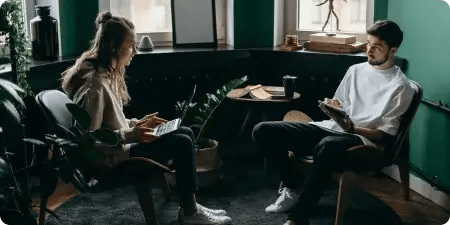 Two professionals in a modern office discussing digital marketing roles and remote career opportunities at BitBop